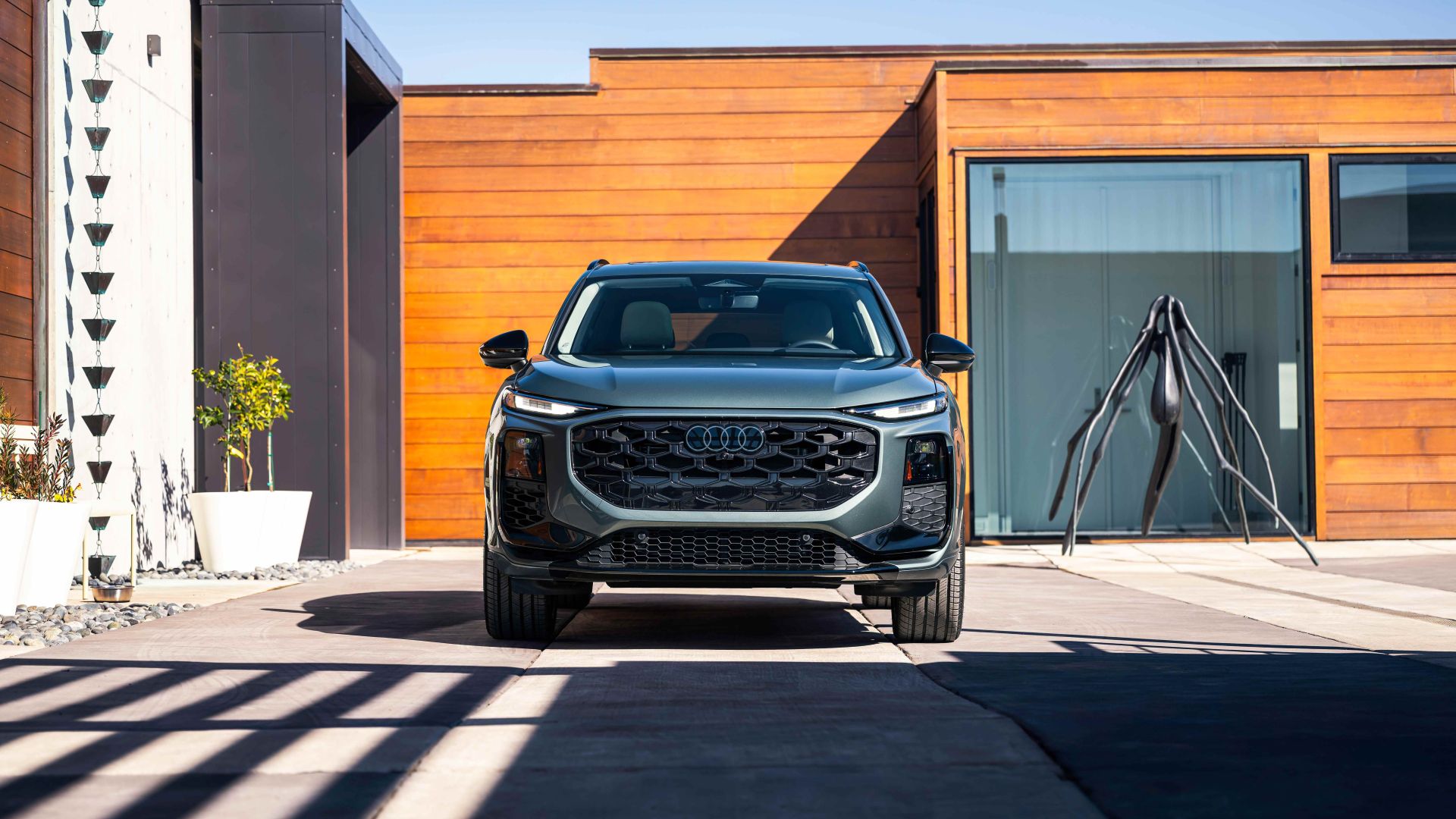 Front profile view of an Audi Q3 parked.